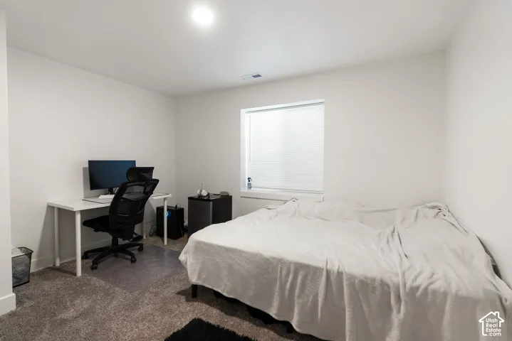 Bedroom featuring neutral carpeting and white walls