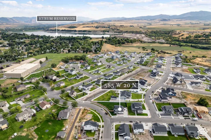 Aerial perspective showcasing a developed residential neighborhood with a mix of established and under-construction homes