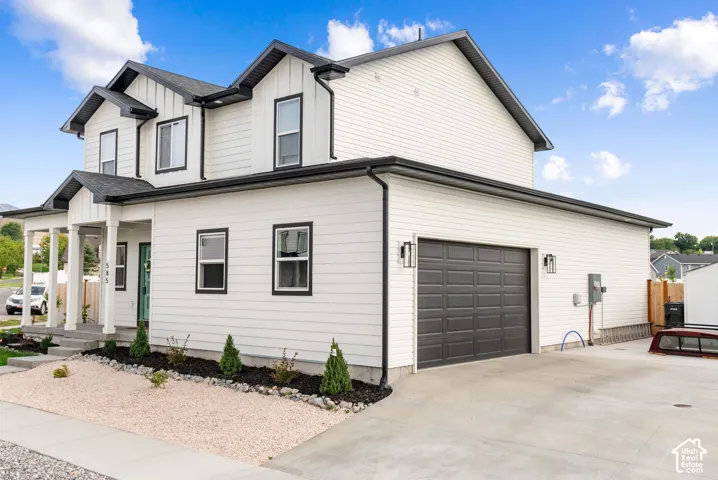 Modern Colonial-style exterior featuring white siding with black trim accents