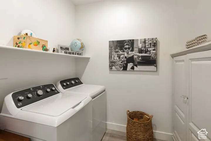 Dedicated laundry area featuring a white storage shelf and a tall white cabinet with glass knobs
