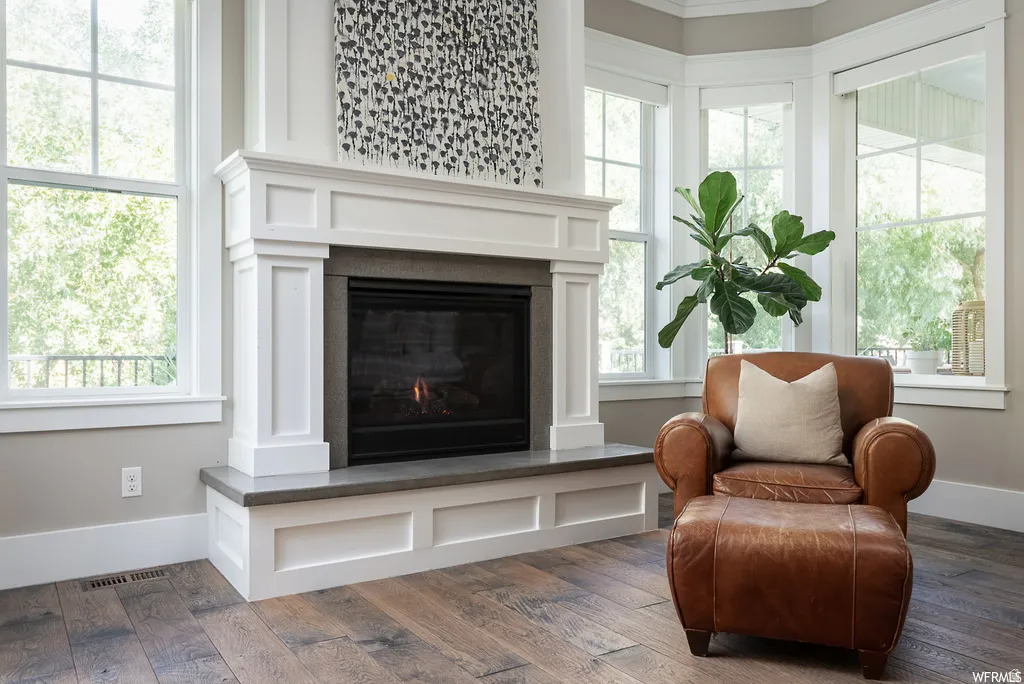 Fireplace with white mantle and hearth, featuring a dark firebox and a gray stone top
