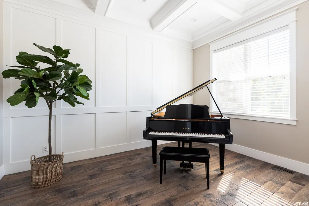 Spacious room featuring wood-finish flooring and wainscoting