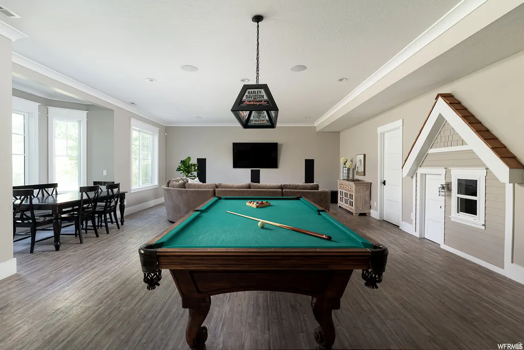 Expansive recreation space featuring a classic billiards table, wood-finish flooring, and recessed ceiling lighting