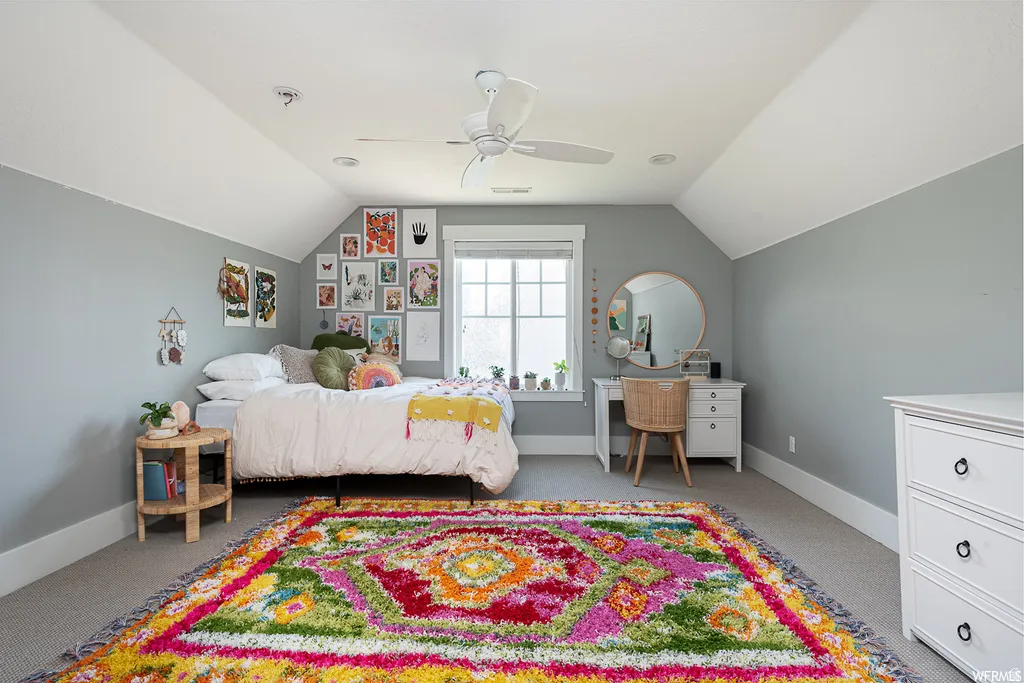 Attic bedroom featuring pitched ceilings, recessed lighting, and a ceiling fan