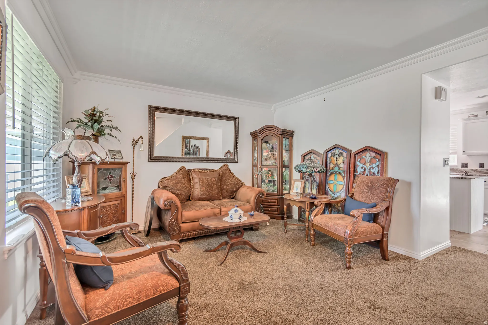 Living area featuring light-colored walls and crown molding
