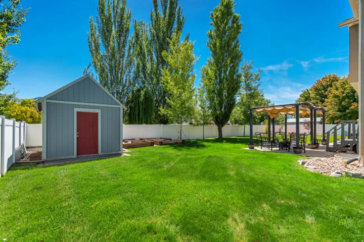 Expansive green lawn with a privacy fence