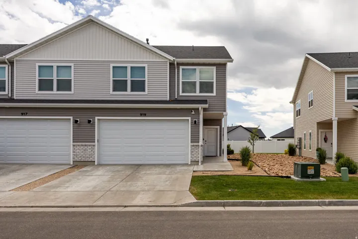 Multi-level residence featuring gray horizontal siding and white trim