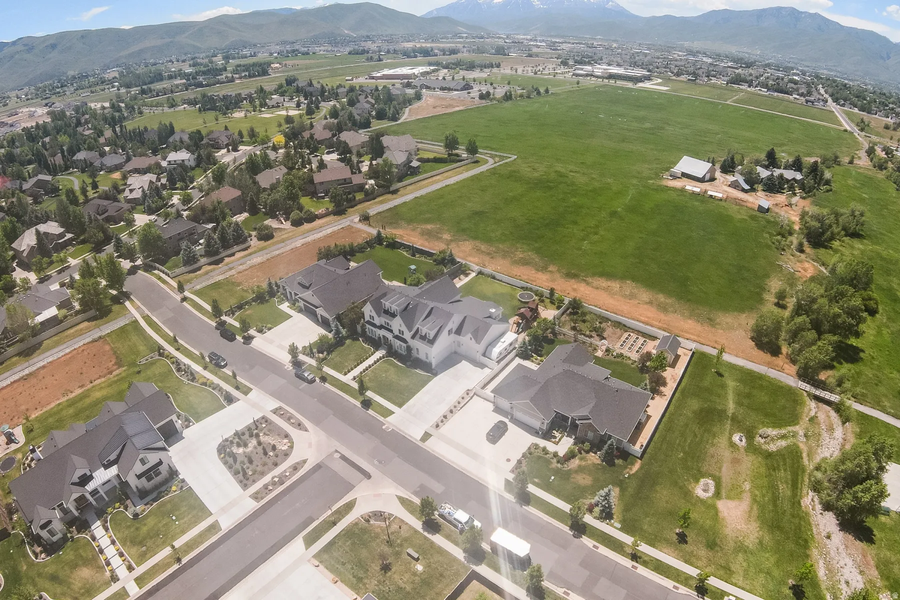 Aerial perspective showcasing a residential neighborhood with mountain backdrops