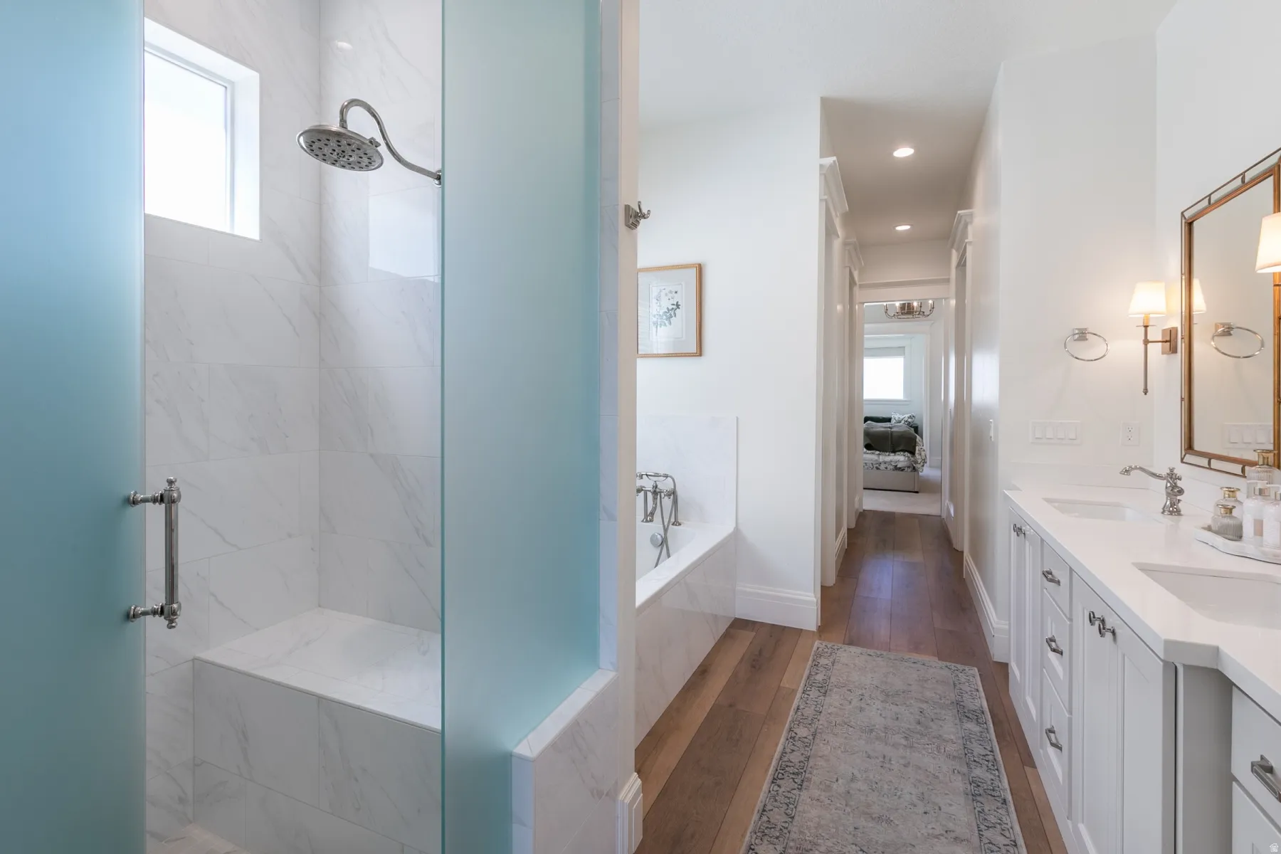 Shower enclosure featuring a built-in bench, rainfall showerhead, and tile surround