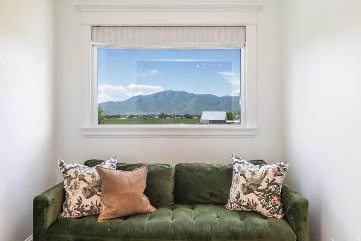 Expansive window with mountain and rural scenery