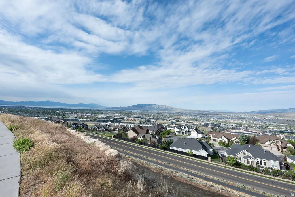 Expansive suburban landscape featuring residential properties and a distant body of water