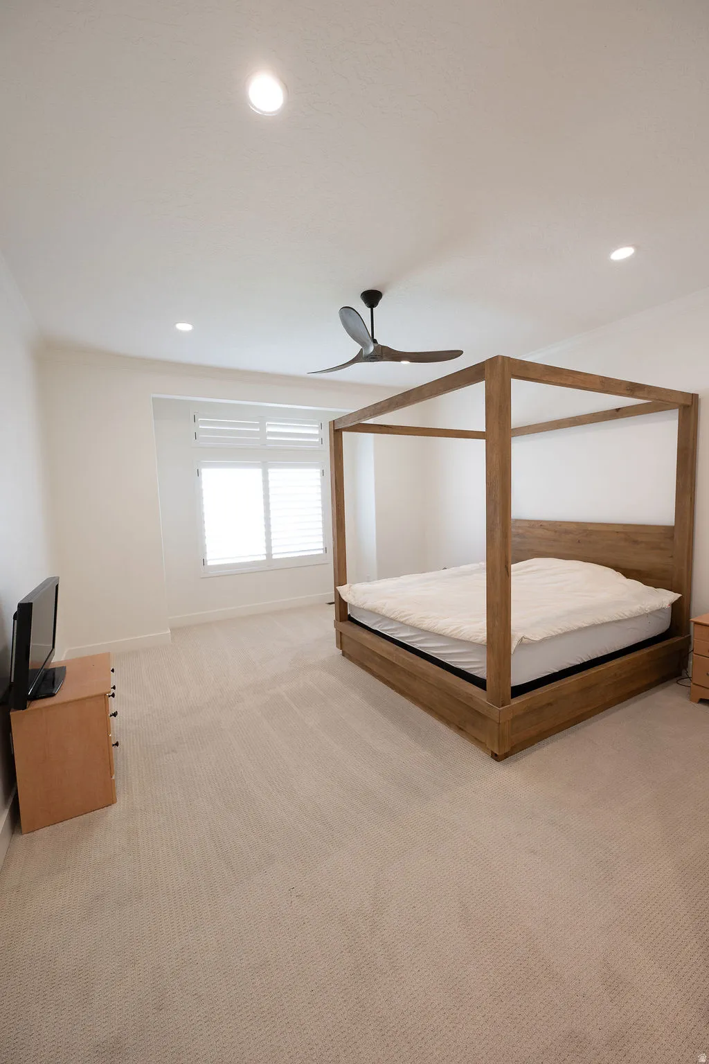 Light-toned wall-to-wall carpeting complements bright white walls