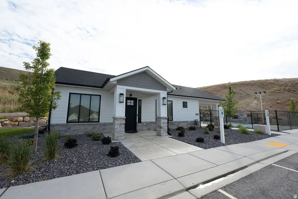 Contemporary single-story residence featuring a black asphalt shingle roof and white horizontal siding