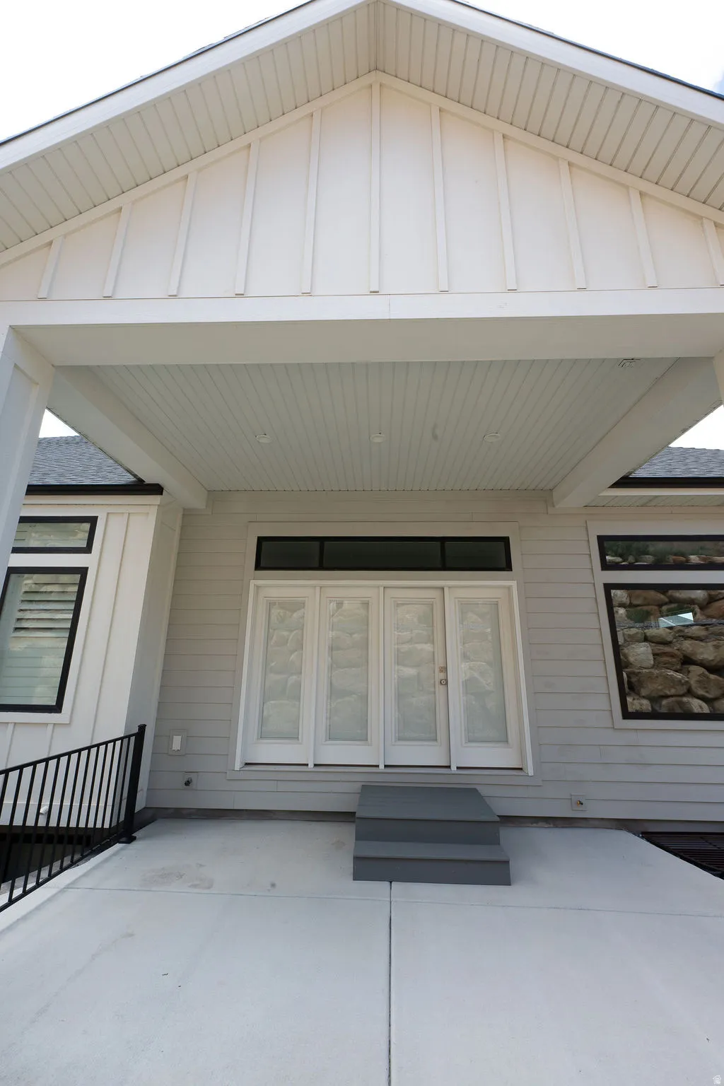 Exterior patio featuring concrete surfacing and a three-step entry