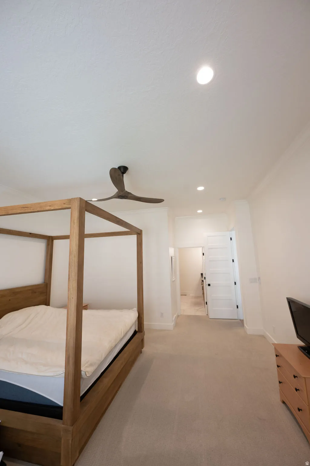 Spacious room featuring neutral carpeting, recessed lighting, and a contemporary ceiling fan