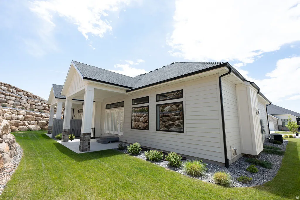 Rear exterior featuring horizontal siding and dark-framed windows