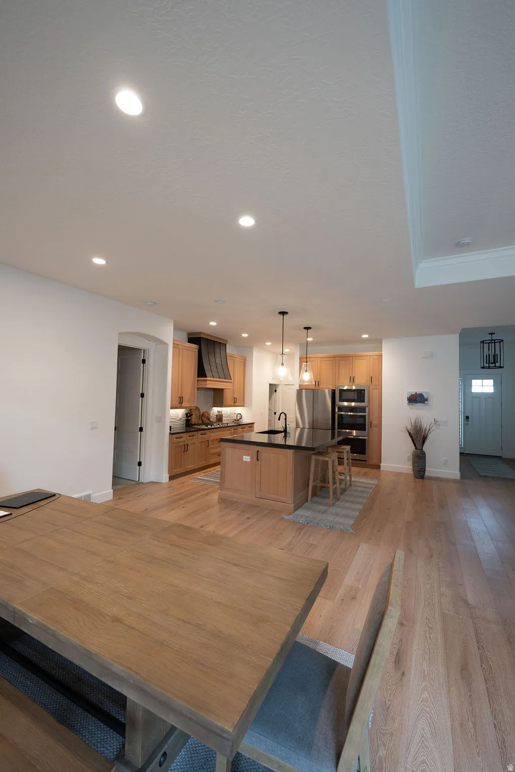 Open-concept living space featuring wood-finish flooring throughout