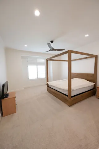 Light-toned wall-to-wall carpeting complements bright white walls