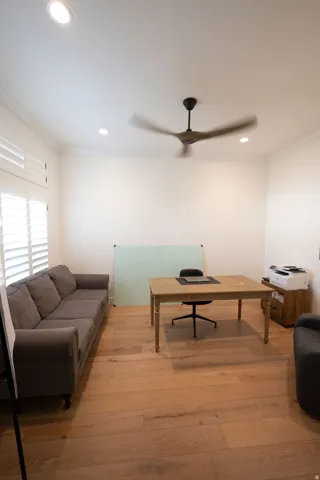 Room featuring wide-plank wood-finish flooring, recessed lighting, and a contemporary ceiling fan