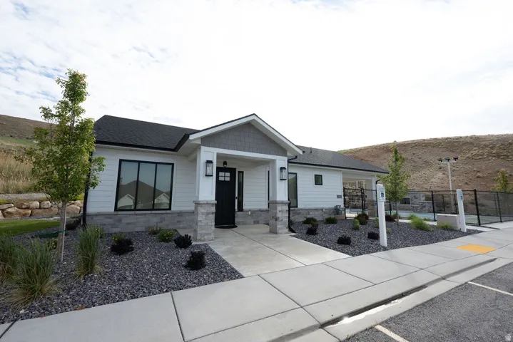 Contemporary single-story residence featuring a black asphalt shingle roof and white horizontal siding