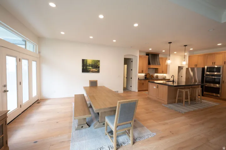 Open-concept living area featuring light wood-finish flooring
