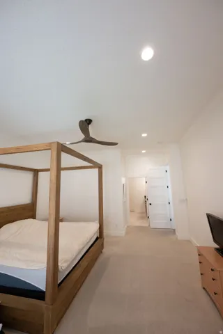 Spacious room featuring neutral carpeting, recessed lighting, and a contemporary ceiling fan
