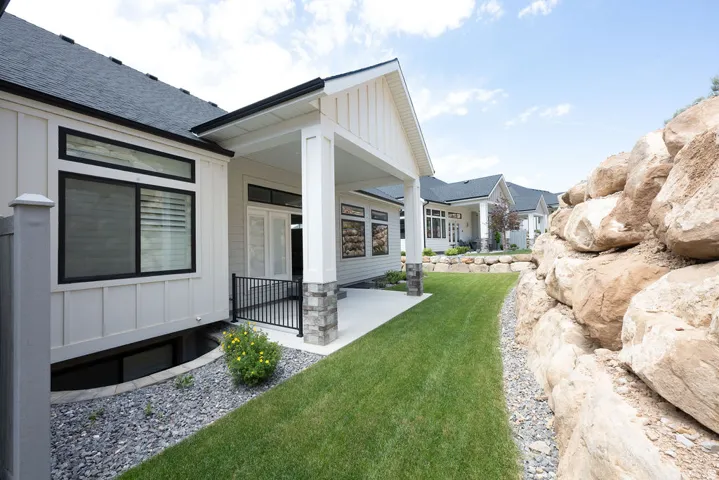 Covered patio area with concrete surfacing and stone-wrapped pillars