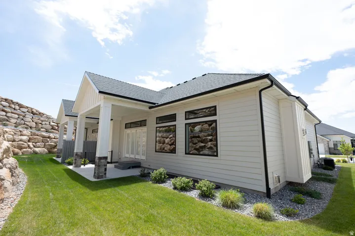 Rear exterior featuring horizontal siding and dark-framed windows