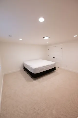 Neutral-toned carpeting and white walls create a bright interior