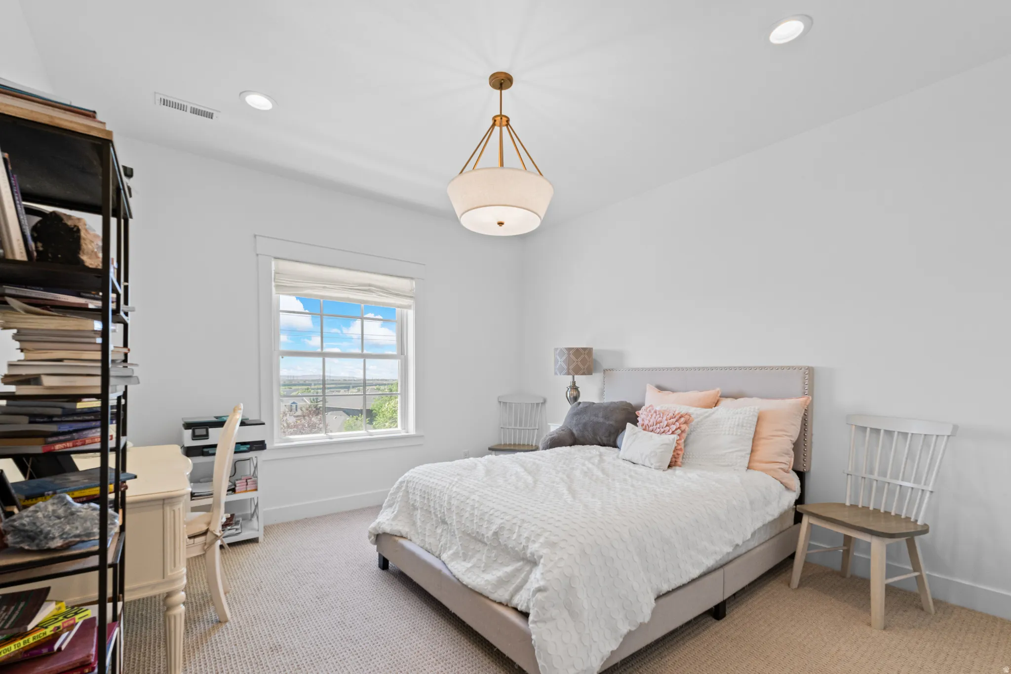 Light-filled room featuring a window with a landscape backdrop, recessed lighting, and a contemporary ceiling fixture