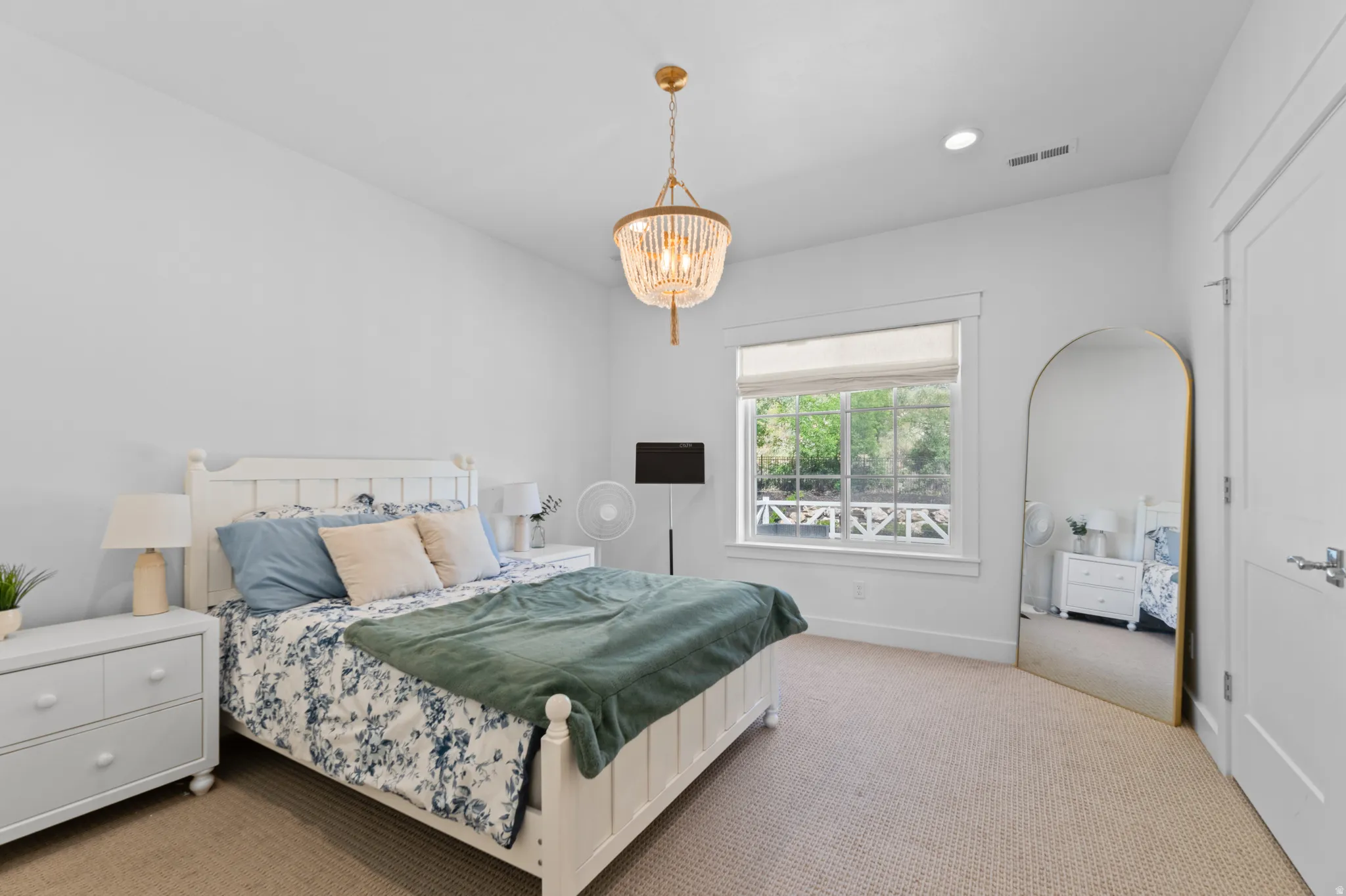 Spacious interior room with white walls and neutral carpet