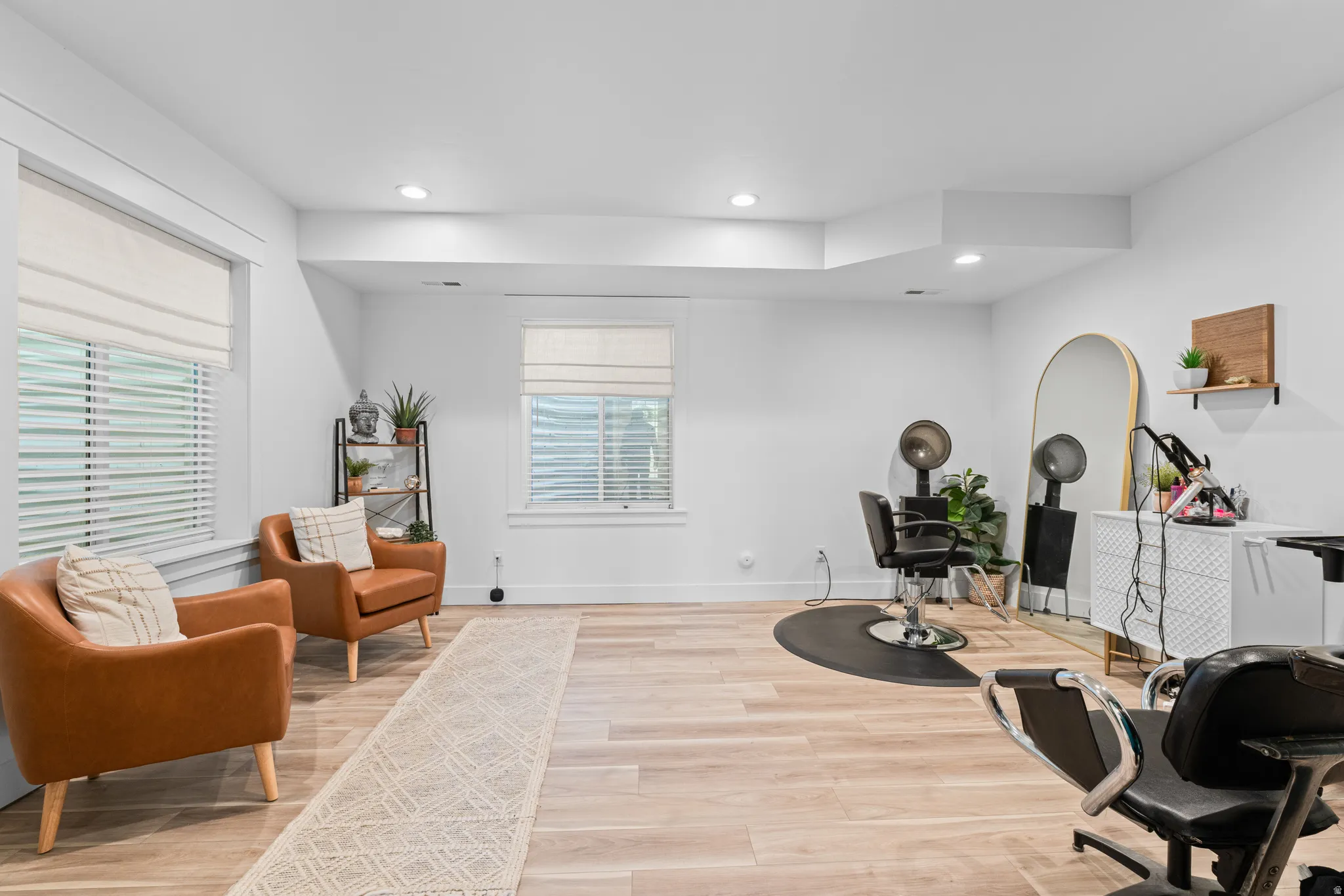 Bright, versatile room featuring light wood-finish flooring and recessed lighting