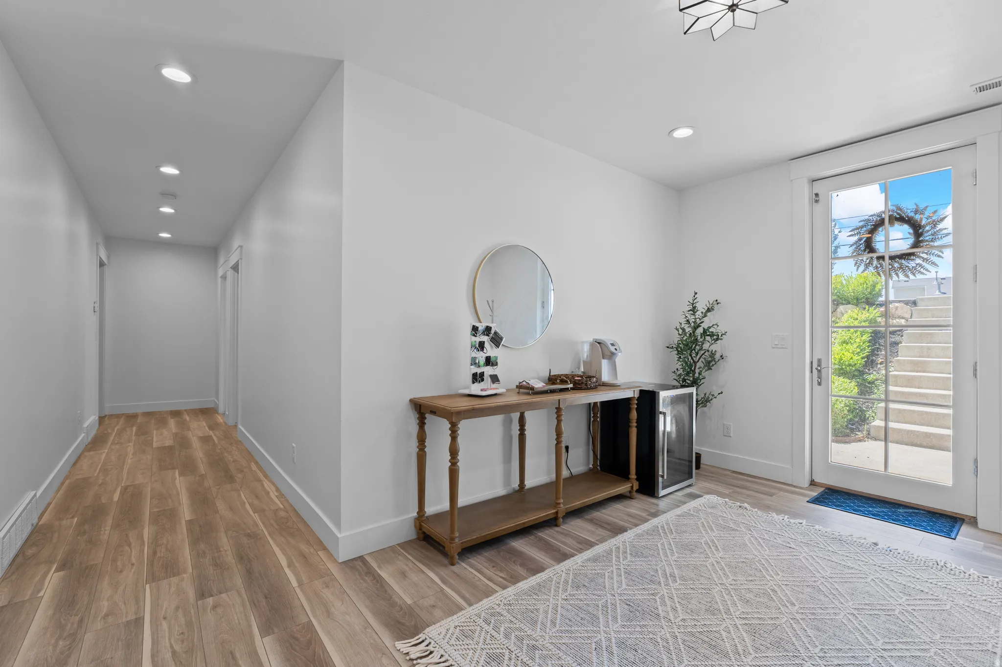 Entryway featuring a glass-paned door, wood-finish flooring, recessed lighting, and a contemporary ceiling fixture
