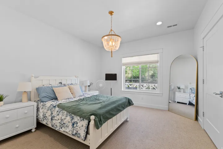 Spacious interior room with white walls and neutral carpet