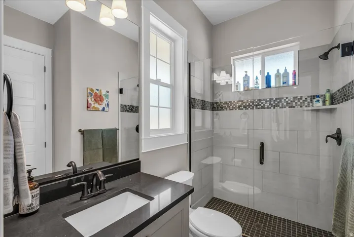 Bathroom with dark countertop vanity, undermount sink, and dark bronze fixtures