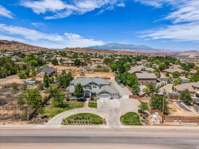 Expansive property featuring a large residence, a circular drive, and an attached three-car garage
