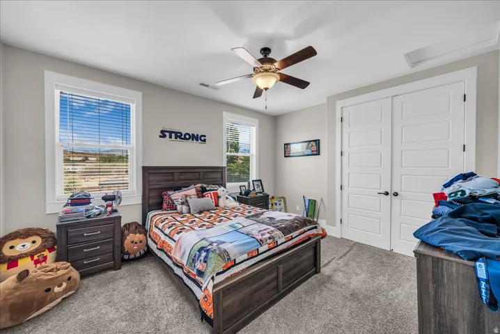 Spacious room featuring neutral carpeting and light gray walls