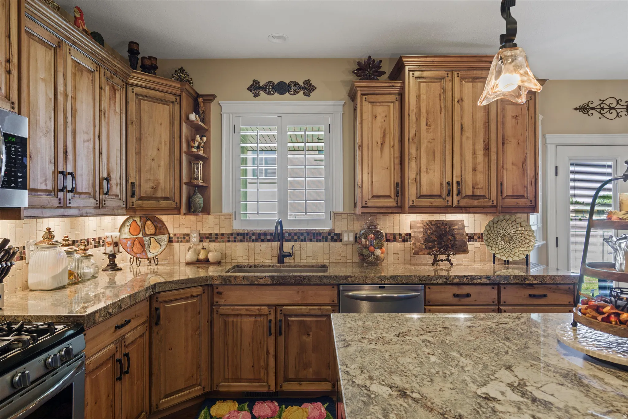 Kitchen featuring wood cabinetry, granite countertops, and a mosaic tile backsplash