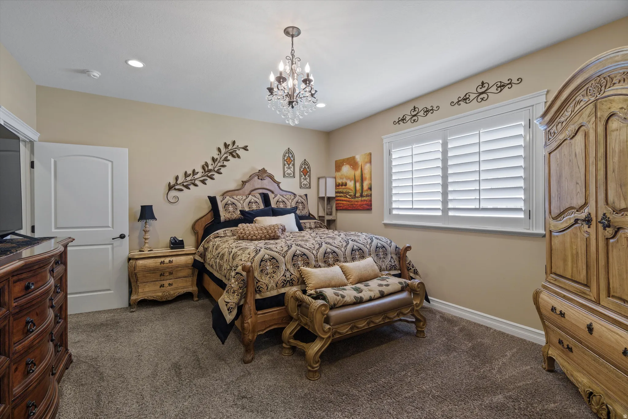 Bedroom featuring carpeting, recessed lighting, and a chandelier light fixture