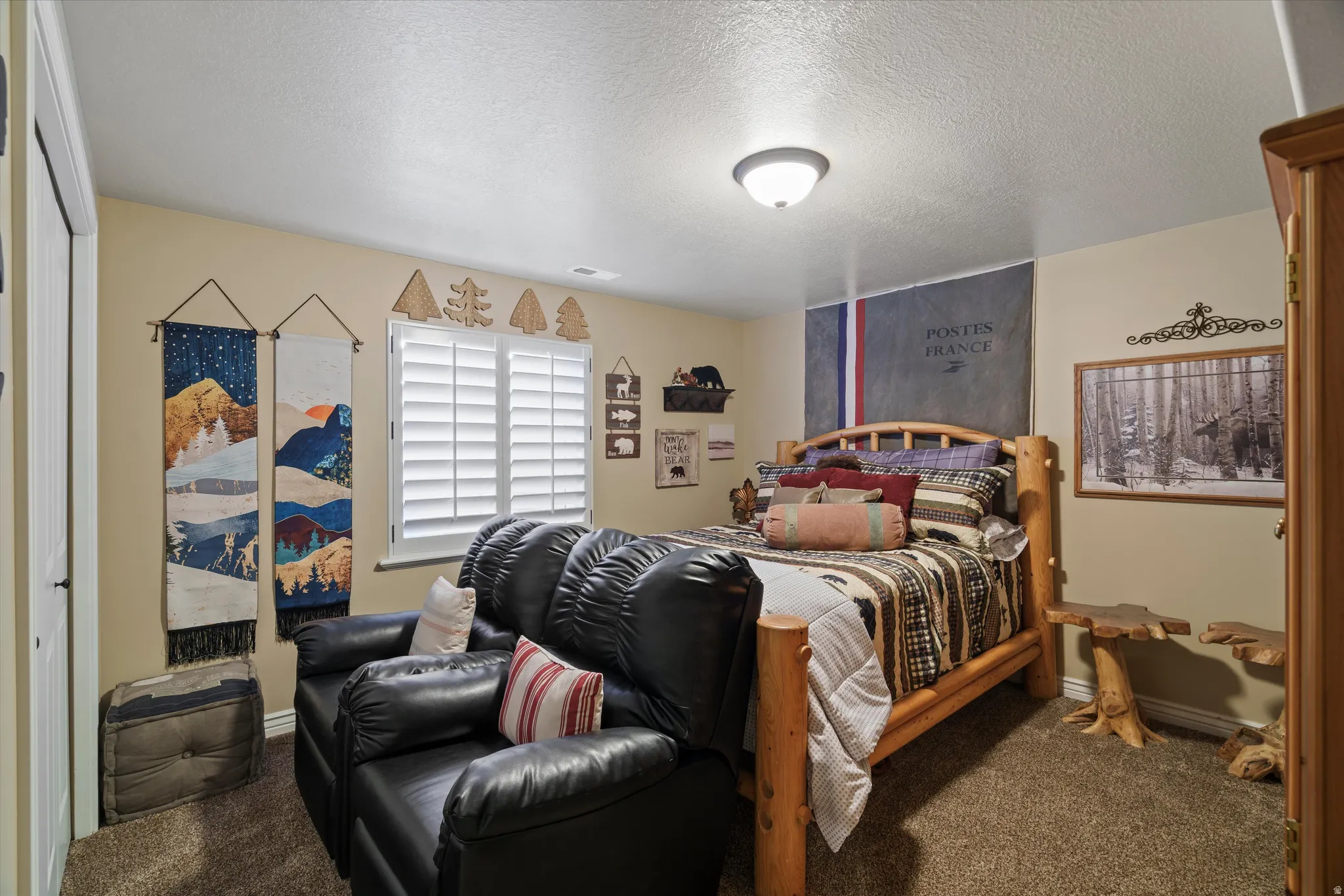 Carpeted room featuring a window with plantation shutters