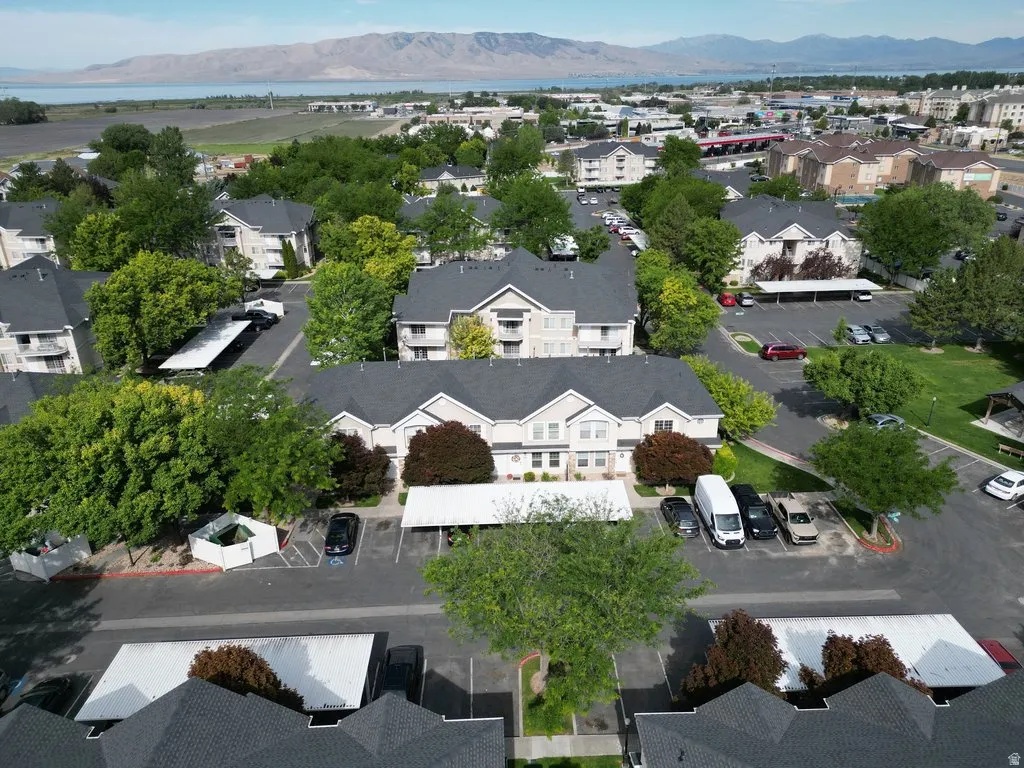 Expansive property featuring multiple multi-story residential buildings with dark shingled roofs and light-colored siding