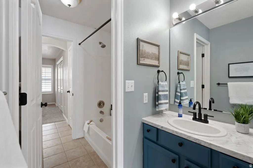 Bathroom featuring a vanity with a dark blue base and white countertop