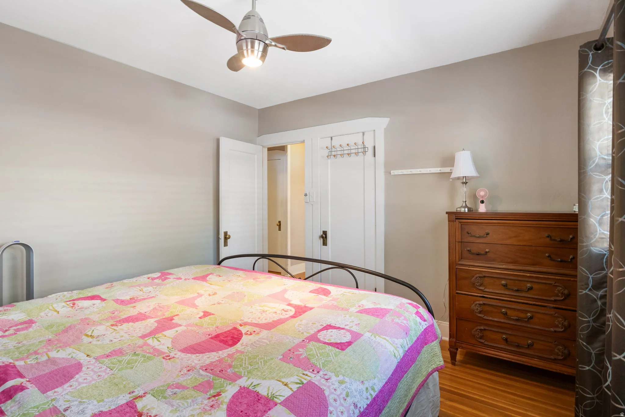 Neutral-toned walls with a built-in closet featuring white louvered doors