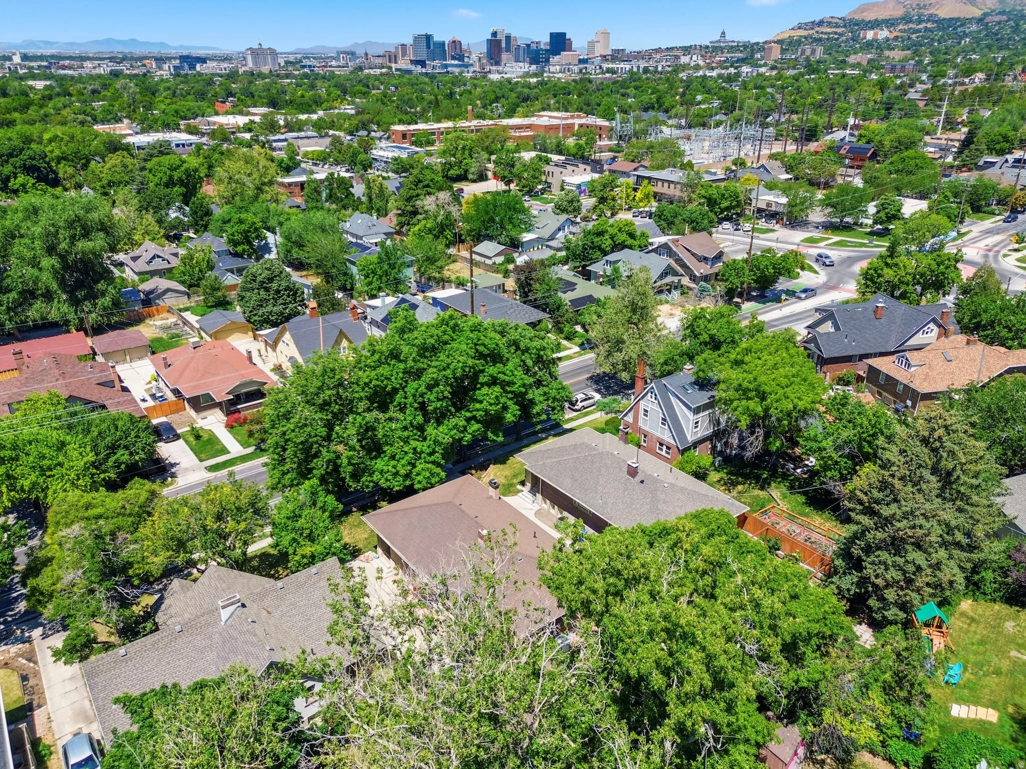 Aerial perspective of a verdant neighborhood with established trees and residential properties