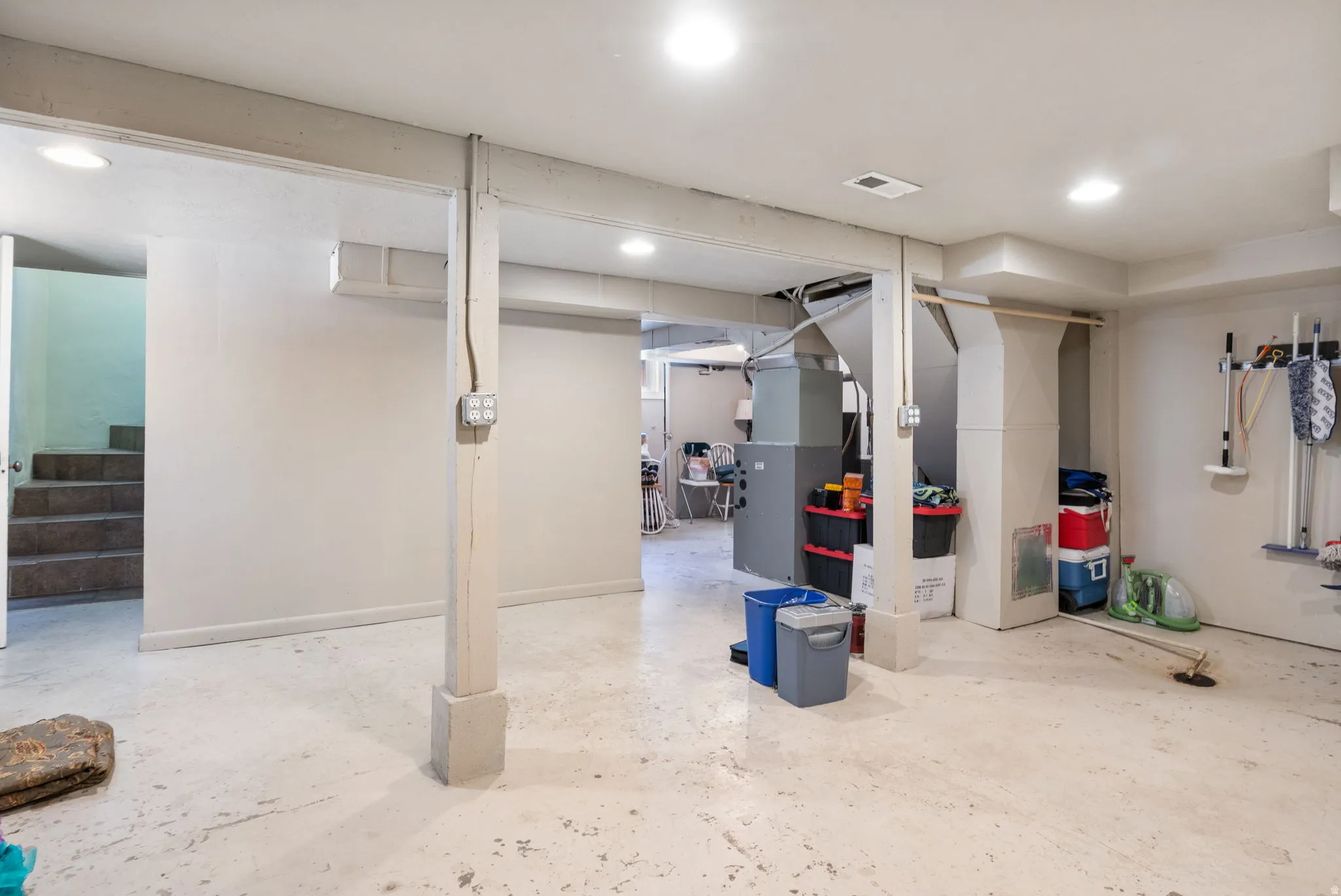 Spacious lower level with painted concrete flooring and recessed lighting