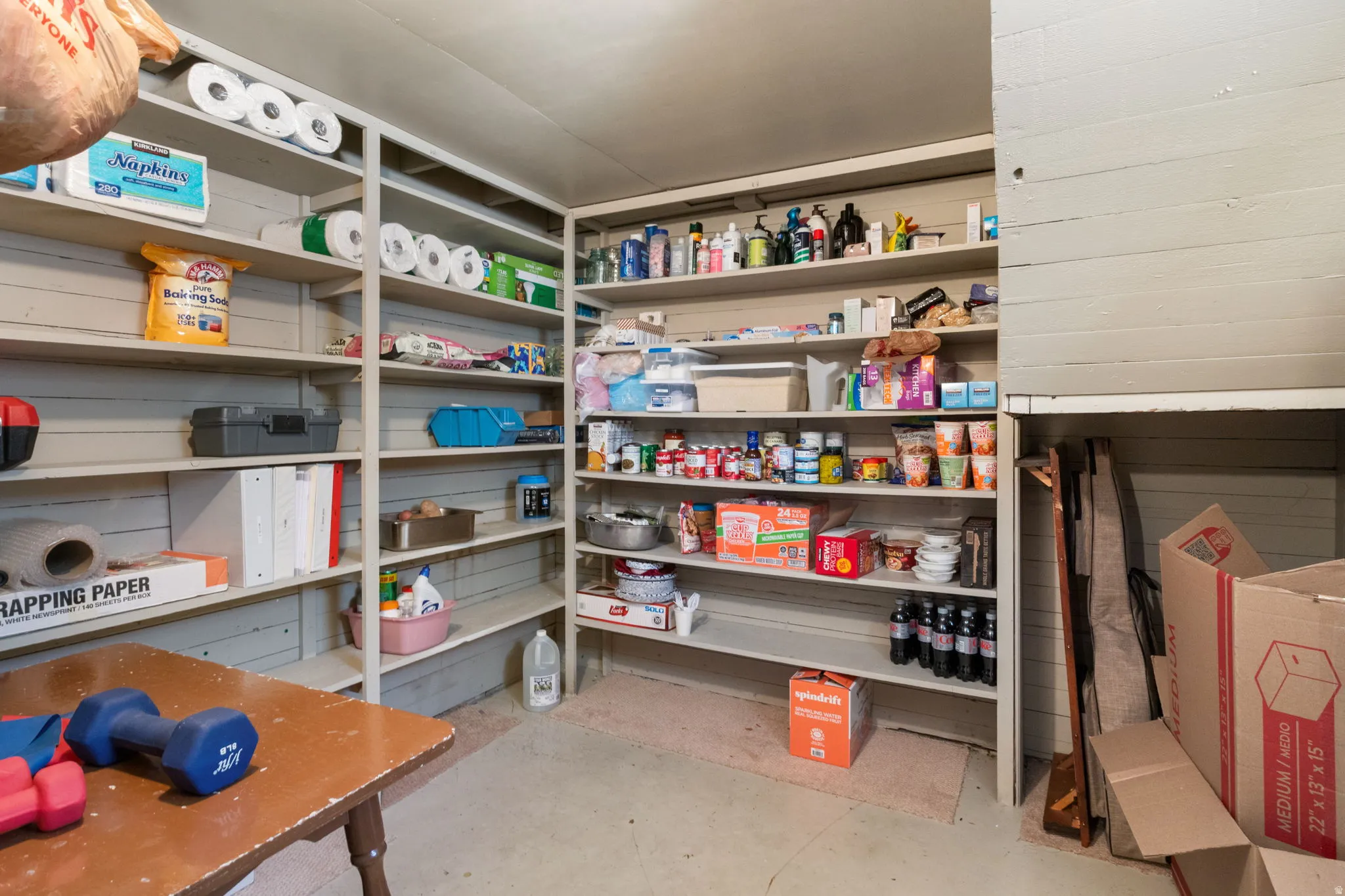Dedicated storage area featuring extensive built-in shelving, providing ample organization options