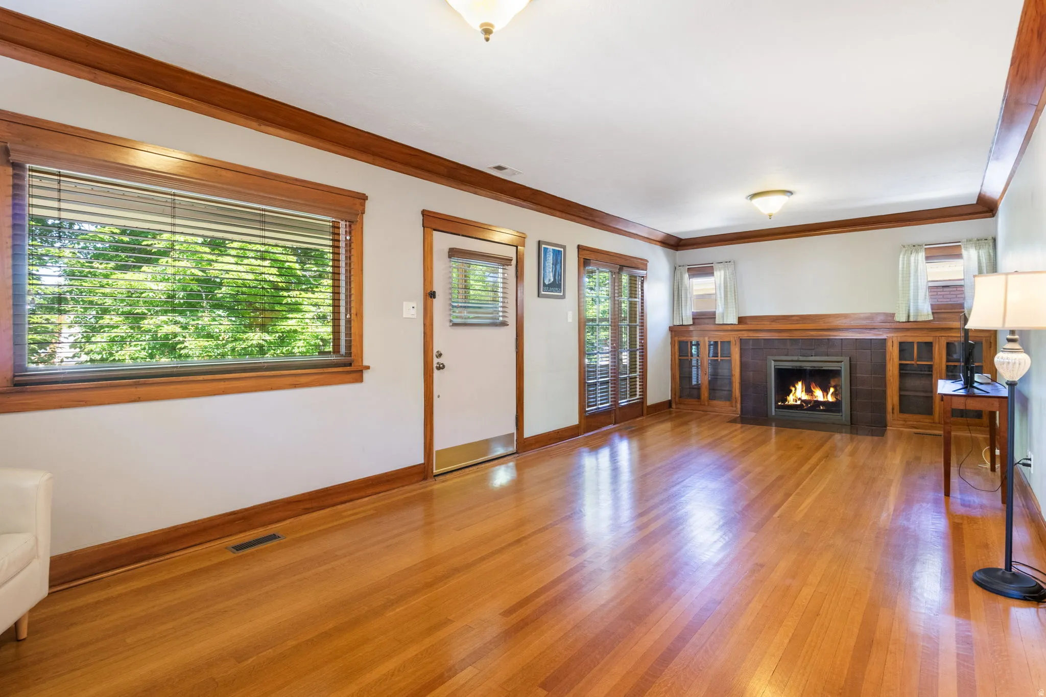 Hardwood flooring extends throughout this room, complemented by extensive wood trim and built-in cabinetry