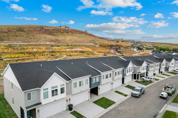Row of contemporary townhomes featuring attached garages and varied exterior finishes