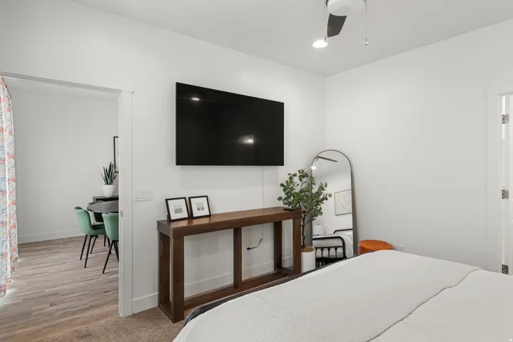 White walls and a contemporary ceiling fan define this space