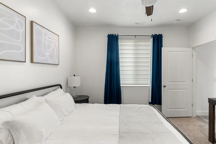 Bedroom featuring a window with blinds, recessed lighting, and a ceiling fan